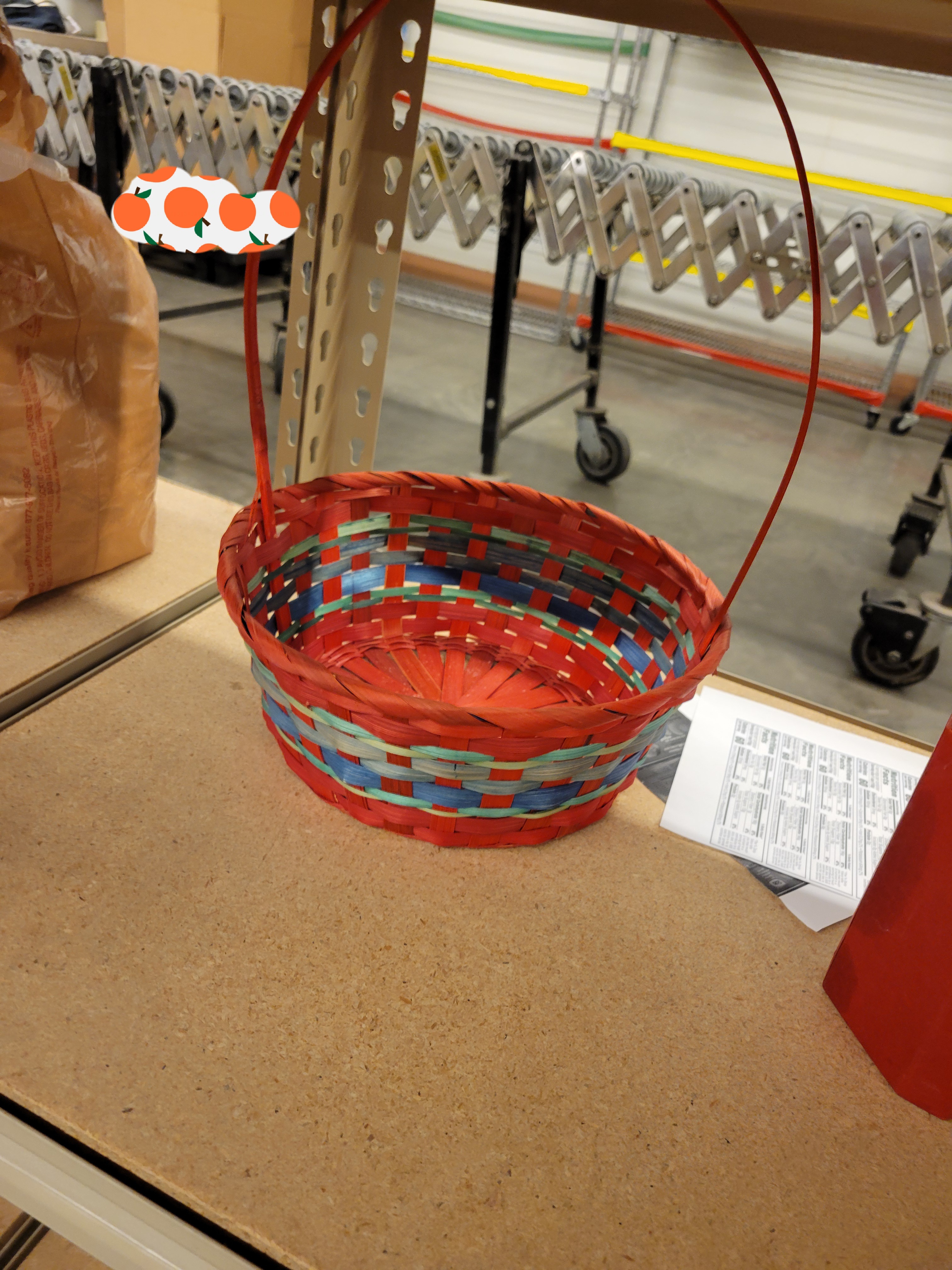 Multi-colored easter basket sits on shelf.